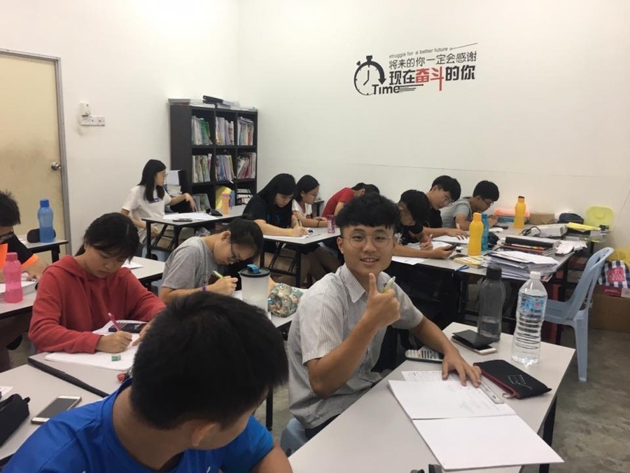 Students studying together in class with Mr Soon